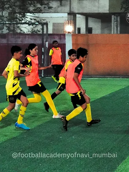 Players in bibs engage in a small-sided game, which is excellent for improving passing, movement, and decision-making in tight spaces.