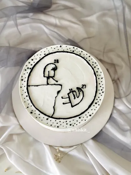Another view of the stick figure cliffhanger cake, a quirky and creative design for a fun-loving person.