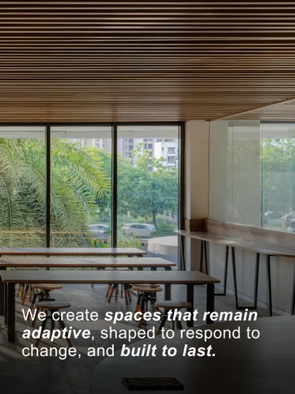 An image of a flexible learning space with a quote overlay emphasizing our commitment. We create spaces that remain adaptive, shaped to respond to change, and built to last.