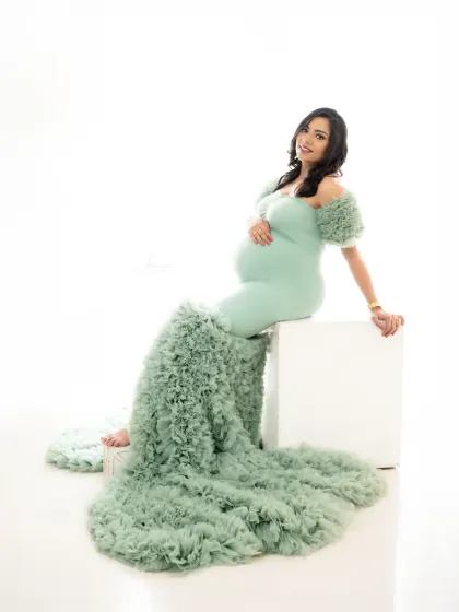 Using simple props like this white block can help create dynamic poses. Here, it allows the stunning train of the mint green gown to cascade beautifully.