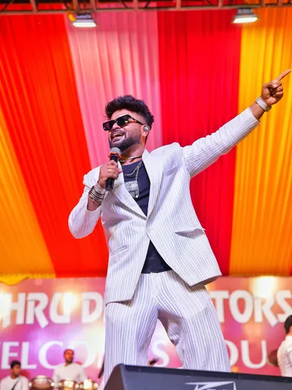 Pointing to the crowd, getting them hyped up during a Navratri performance.