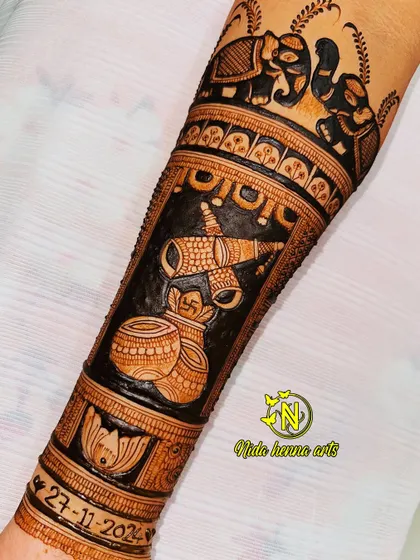 This bridal arm design incorporates traditional wedding symbols like the shehnai and kalash. I also personalized it by adding the wedding date, 27-11-2024, as a lasting memory.