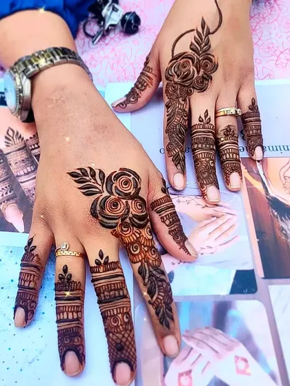 A focus on finger details, with intricate bands and a single rose motif.