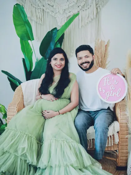 A happy gender reveal moment captured in our boho studio setup. We can incorporate announcement props to make your photos even more memorable.