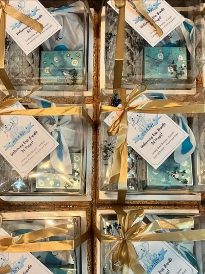 A top-down view of the baby announcement hampers, all packed and ready to go. The consistent theme and beautiful packaging make for a stunning collective presentation.