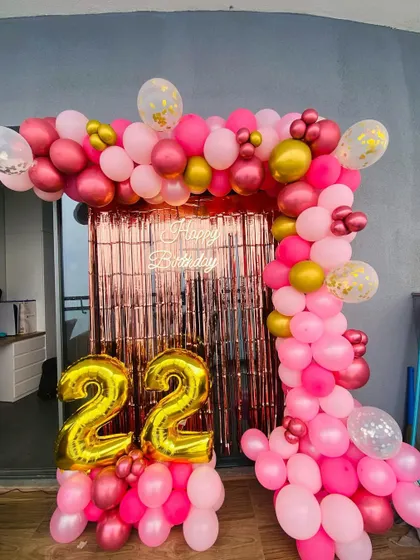 Another view of the pink and gold 22nd birthday balloon arch.