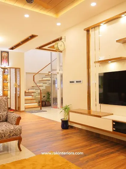 A different angle of the Calicut living room, showing the staircase and the open, multi-level design of the home.