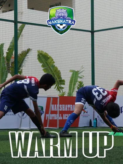 Every session begins with a proper warm-up. Two of our young athletes perform stretching exercises to prepare their bodies and prevent injuries before training.