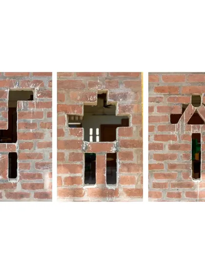Playful cutouts in the brick walls of the Spastic Society classroom, shaped like animals. These small details spark imagination and bring a sense of delight to the learning space.