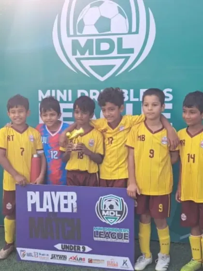 Our U9 team celebrating a player's Man of the Match award at the Mini Dribblers League.