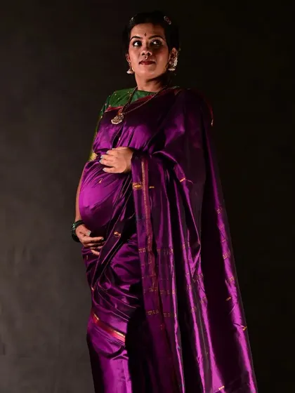 A full-length portrait from the traditional maternity shoot. The makeup, hair, and saree drape all come together to create a look of timeless grace.