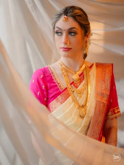 An ethereal portrait of the bride, with a sheer curtain softly diffusing the light and creating a dreamy effect.