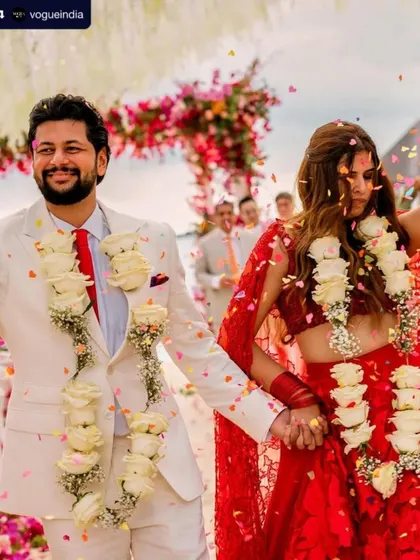 The happy couple after their ceremony. Her makeup is fresh and natural, a perfect complement to the joyous and relaxed atmosphere of their beach wedding. It was a day filled with love and double rainbows.