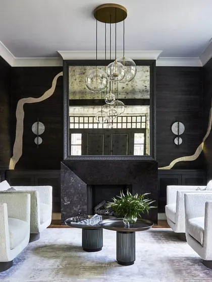 We transform walls into masterpieces with sophisticated specialty wallcoverings. Here, the "Adorn" design by Phillip Jeffries, inspired by Kintsugi, uses free-flowing metallic lines to create a dramatic and luxurious living space.