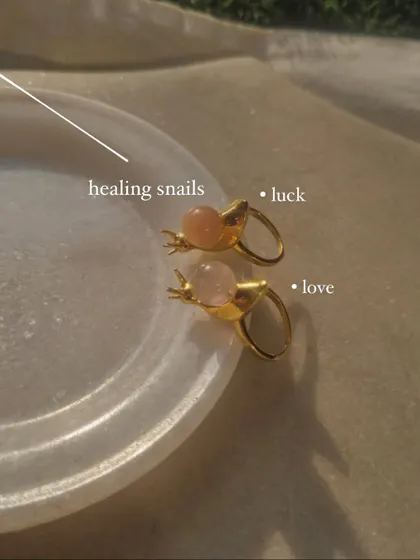 A collection of my healing snail rings. The Peach Moonstone version is for luck, while the Rose Quartz version is for love.