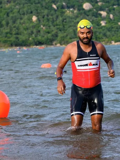 An athlete emerging from the water during the swim leg of a triathlon. We prepare our swimmers for real-world open water conditions, so they feel confident and ready on race day.