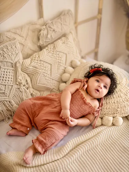 Relaxing in a sea of comfy pillows. This five-month-old looks so peaceful in this boho-chic setup with neutral tones and soft fabrics.