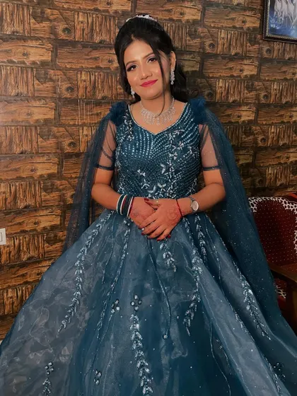 The bride looking confident and happy, ready for her engagement ceremony in her beautiful teal gown.