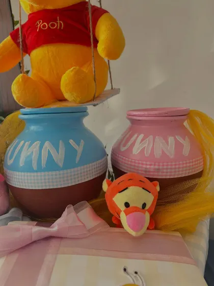 A close-up of the pink and blue 'hunny' pots for the twins.
