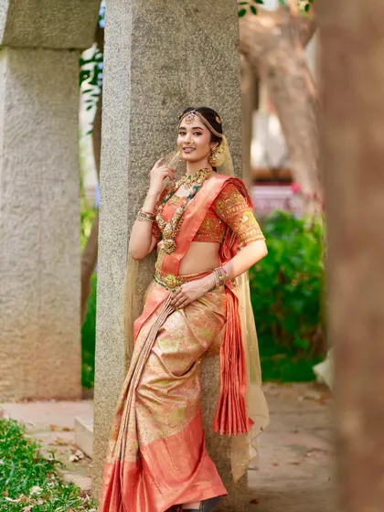 Another angle showcasing the full bridal attire. The jewellery is chosen to enhance the bride's features and the richness of her outfit without overwhelming her.