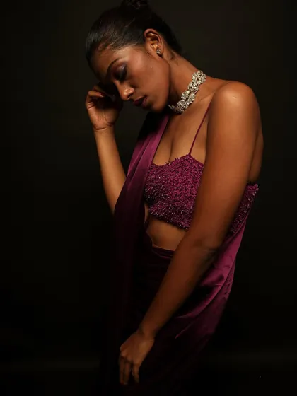 A moody and artistic shot. The makeup, especially the hint of purple on the eyes, adds to the dramatic and emotional feel of the photograph.