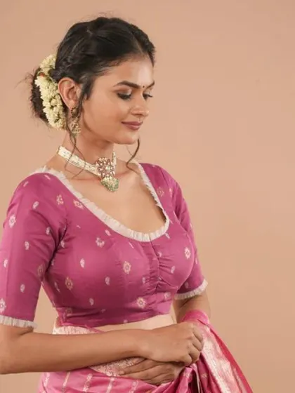 A pink Jamdani cotton blouse with a scoop neckline and delicate ruffled trim.