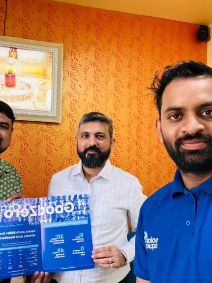 Our team with a customer holding our "GoodZero" brochure.