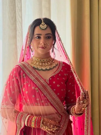 My bride Neha, looking elegant and serene as she holds her dupatta, ready for her wedding ceremony.