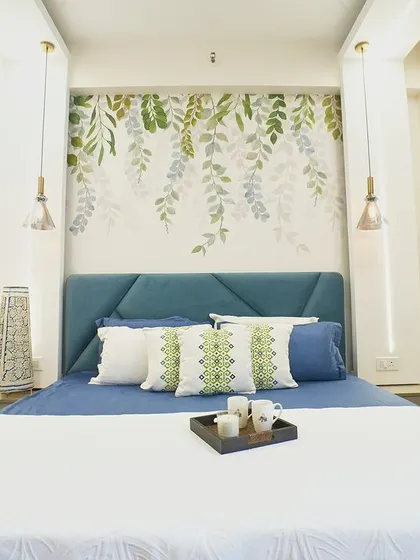 The full view of the bed, showing the simple yet elegant styling. The pendant lights on either side of the bed provide perfect lighting for reading.