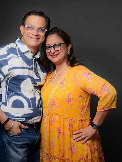 A classic, smiling portrait of the couple celebrating 25 years together. Their comfort with each other is evident.