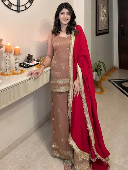 Another one of my favorite festive outfits. This elegant brown suit set with gold embroidery and a vibrant red dupatta is perfect for a Diwali celebration at home.