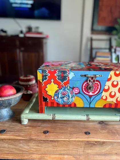 A side view of the Turkish-inspired memory box, showing the vibrant patterns and a pomegranate motif, symbolizing abundance.