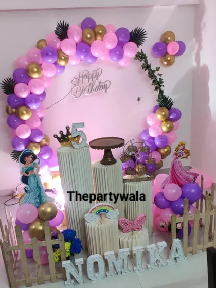 A lovely princess theme with a pink and purple balloon arch, perfect for a 5th birthday party.