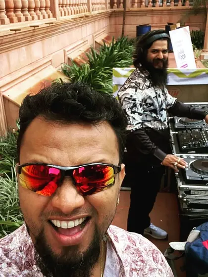 A fun selfie with my co-DJ at an outdoor resort party. We're all about bringing good vibes and great music, wherever the party is.