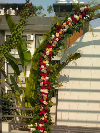 A detailed shot of the beautiful floral garland made of red, pink, and white roses, used to create the romantic arch.