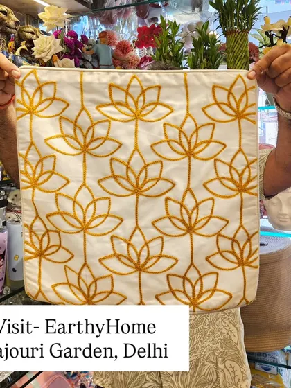 Our premium hand-embroidered cushion cover featuring a golden lotus pattern. The elegant design and quality stitching make it a luxurious addition to any home.