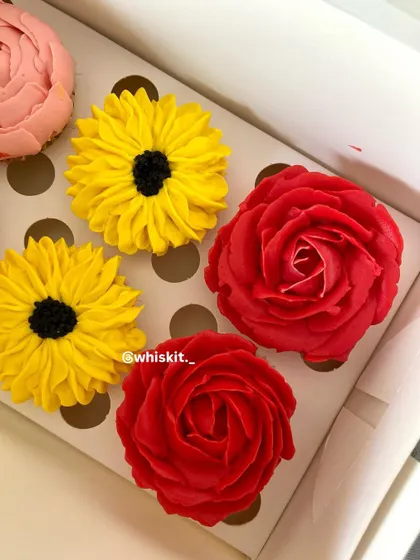 A close-up of my handcrafted floral cupcakes, showcasing the detailed piping work on the red roses, yellow sunflowers, and pink peonies. These are almost too pretty to eat.