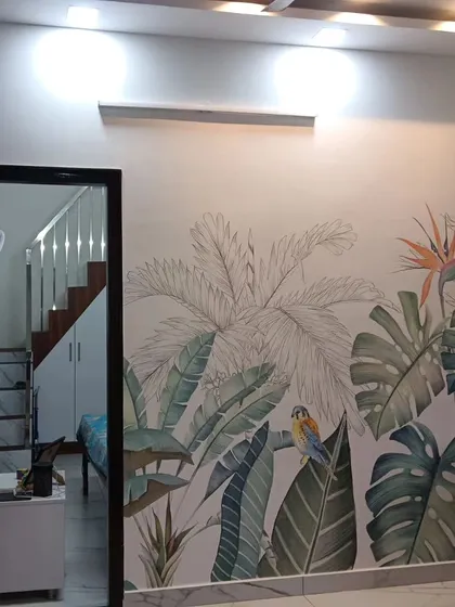 A living room with a large-scale tropical leaf mural, creating a stunning and vibrant feature wall.