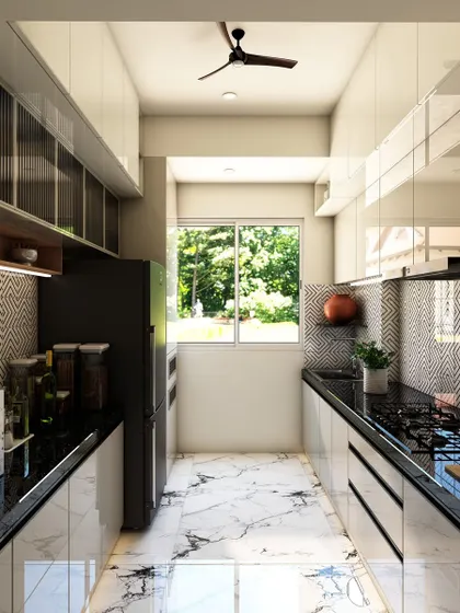 A full view of the galley kitchen, demonstrating how the reflective surfaces and light color palette make the narrow space feel brighter and more open.