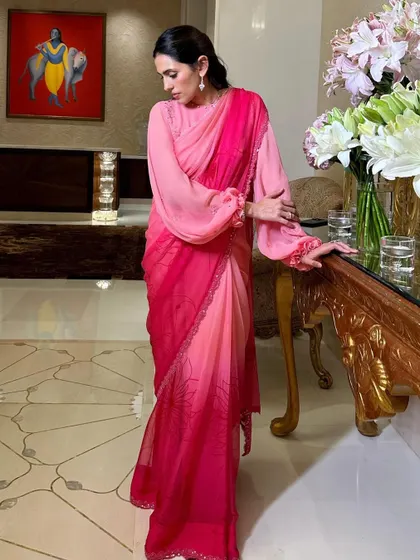 Pretty in pink. This ombre pink saree by Manish Malhotra with full bishop sleeves is a modern, romantic, and incredibly chic look.