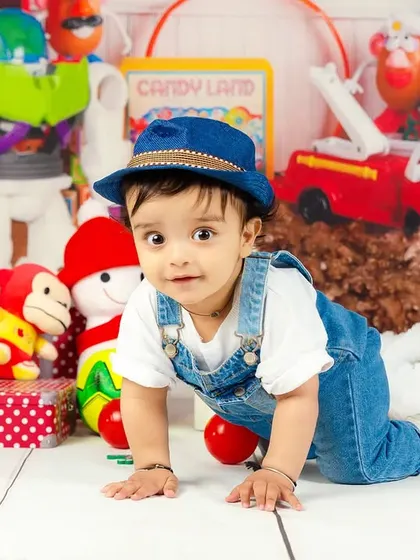 This little explorer is on the move, crawling through his toy-filled wonderland with a cute blue hat on.