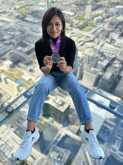 On top of the world, or at least on top of Chicago. Posing with my marathon medal on the glass floor of the Willis Tower. A celebration with a view.