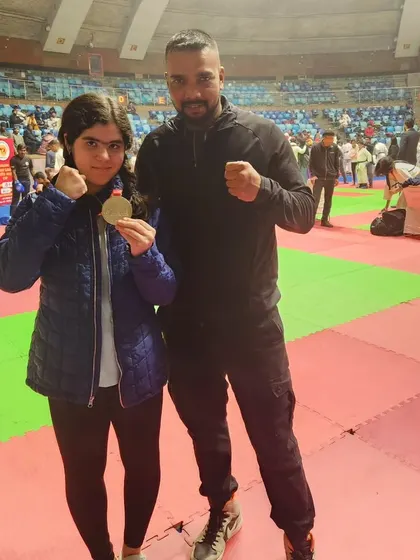 A proud moment with one of my young female students after she won her medal.