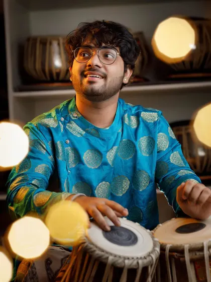 A happy moment with my tabla, surrounded by festive lights. Music brings light and joy, and I hope to share that feeling in every performance.