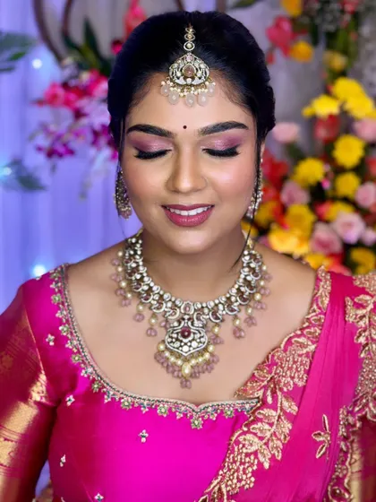 A close-up of the beautiful pink-toned eye makeup and flawless skin.