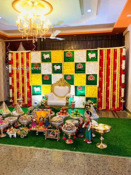 Another setup featuring the sheep and lotus theme, this time with a red and yellow color scheme. The arrangement of offerings in the foreground completes this festive look.