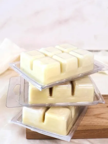 Melted soy wax means endless comfort. A stack of our classic wax melt clamshells.