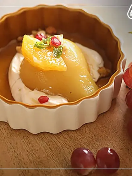 A healthy dessert of poached pear with yogurt and pomegranate. We believe in offering sweet treats that are made with natural ingredients and no refined sugar.