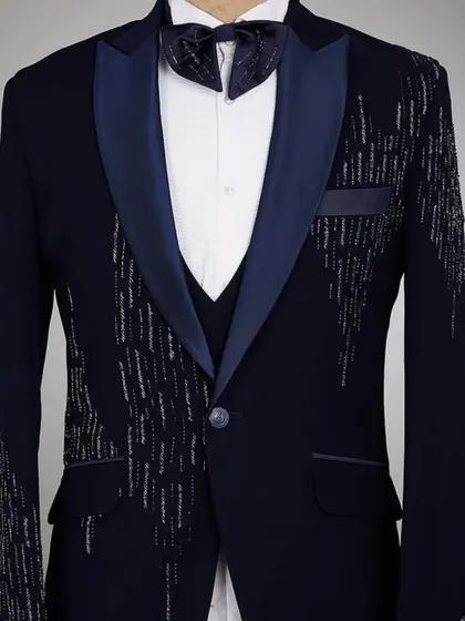 A navy blue tuxedo jacket with a unique silver sparkle pattern. It's a great piece for a New Year's or cocktail party.
