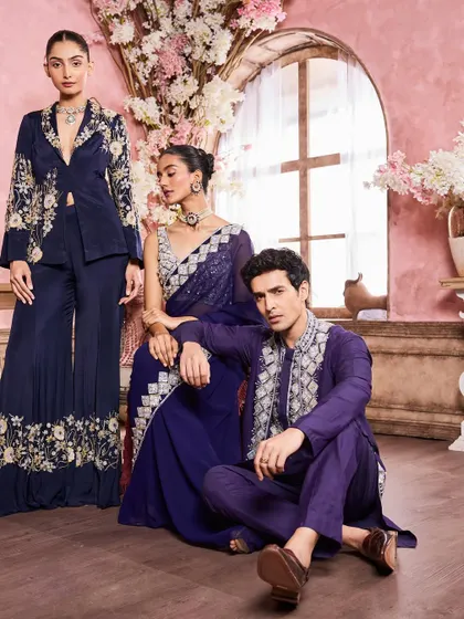 A full-length group shot showcasing a range of embroidered evening wear. My work involved creating a cohesive makeup direction for the entire campaign, from the men's natural look to the women's glamorous style.